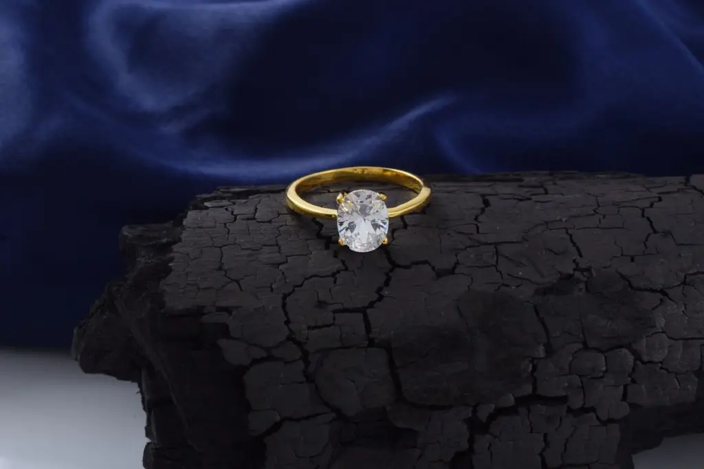 Anillo de oro con piedra engastada en garras visto de cerca