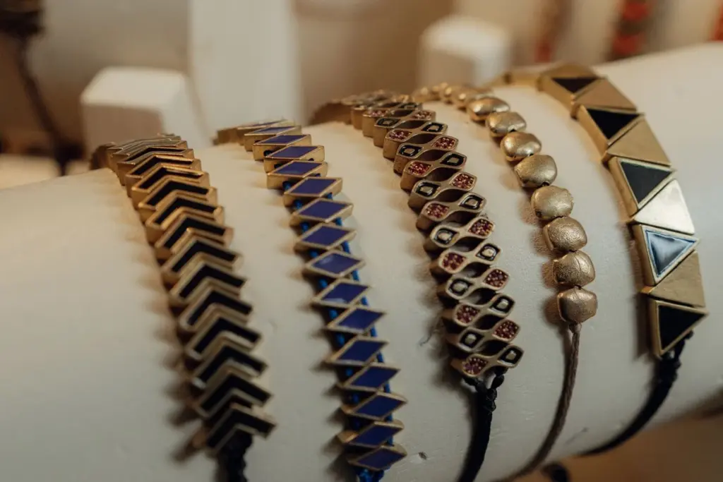Pulseras de cordón con piezas doradas en un expositor
